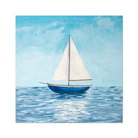 Sailboat on water with a blue sky background