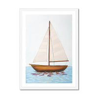 Framed artwork of a sailboat on water with a white border