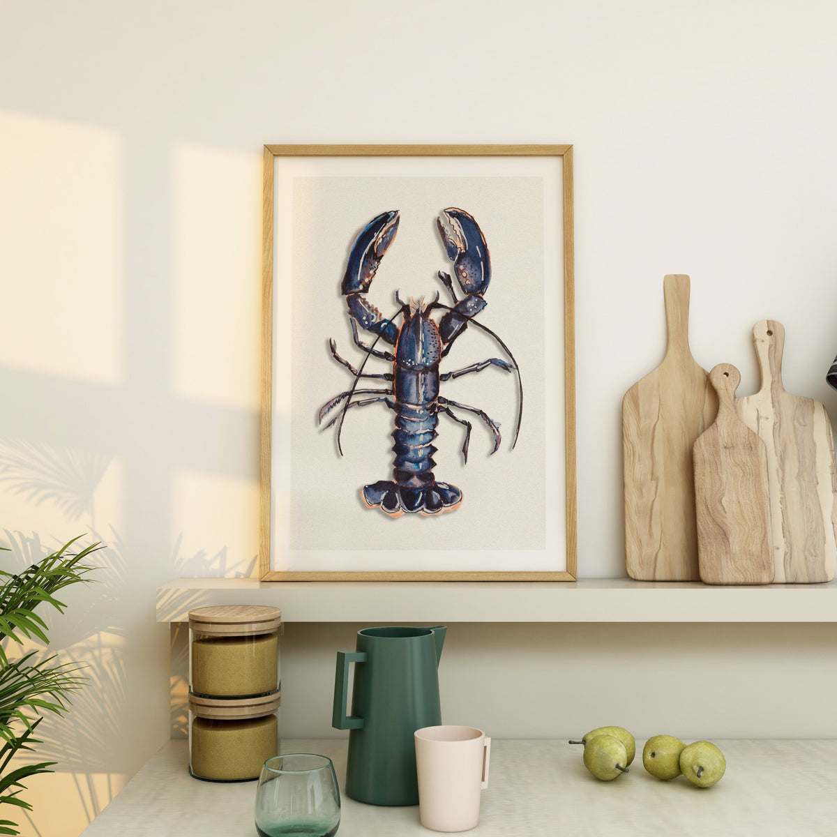 Framed blue lobster kitchen wall art above a shelf