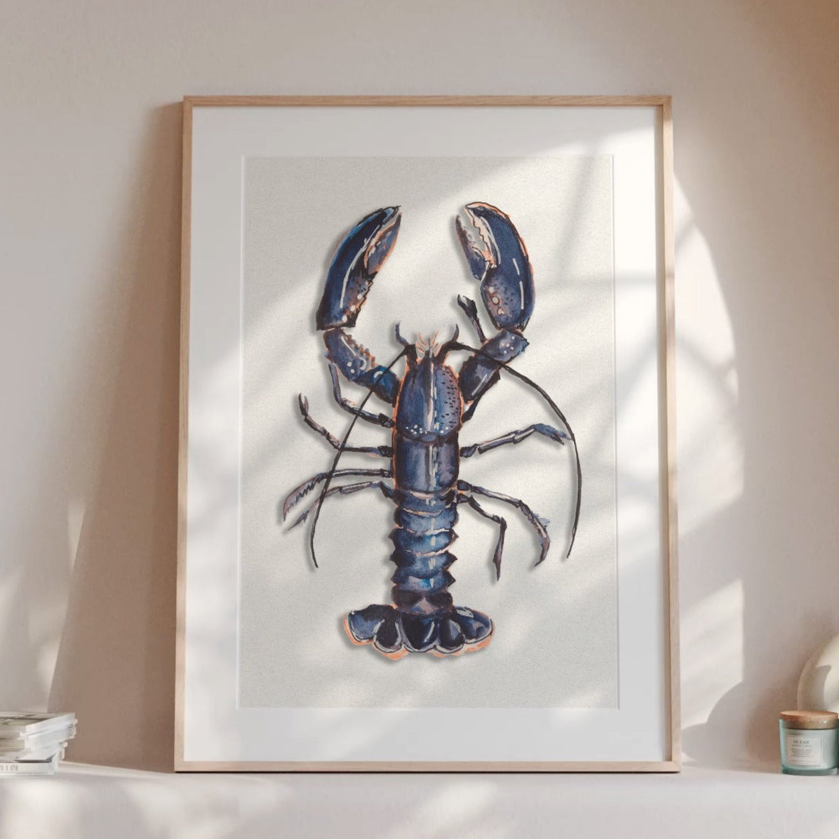 Blue lobster wall art print styled in a neutral kitchen interior