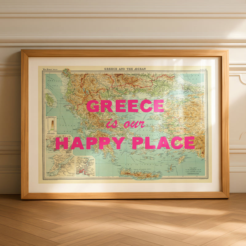Framed map of Greece with 'Greece is our Happy Place' text on a wooden floor.
