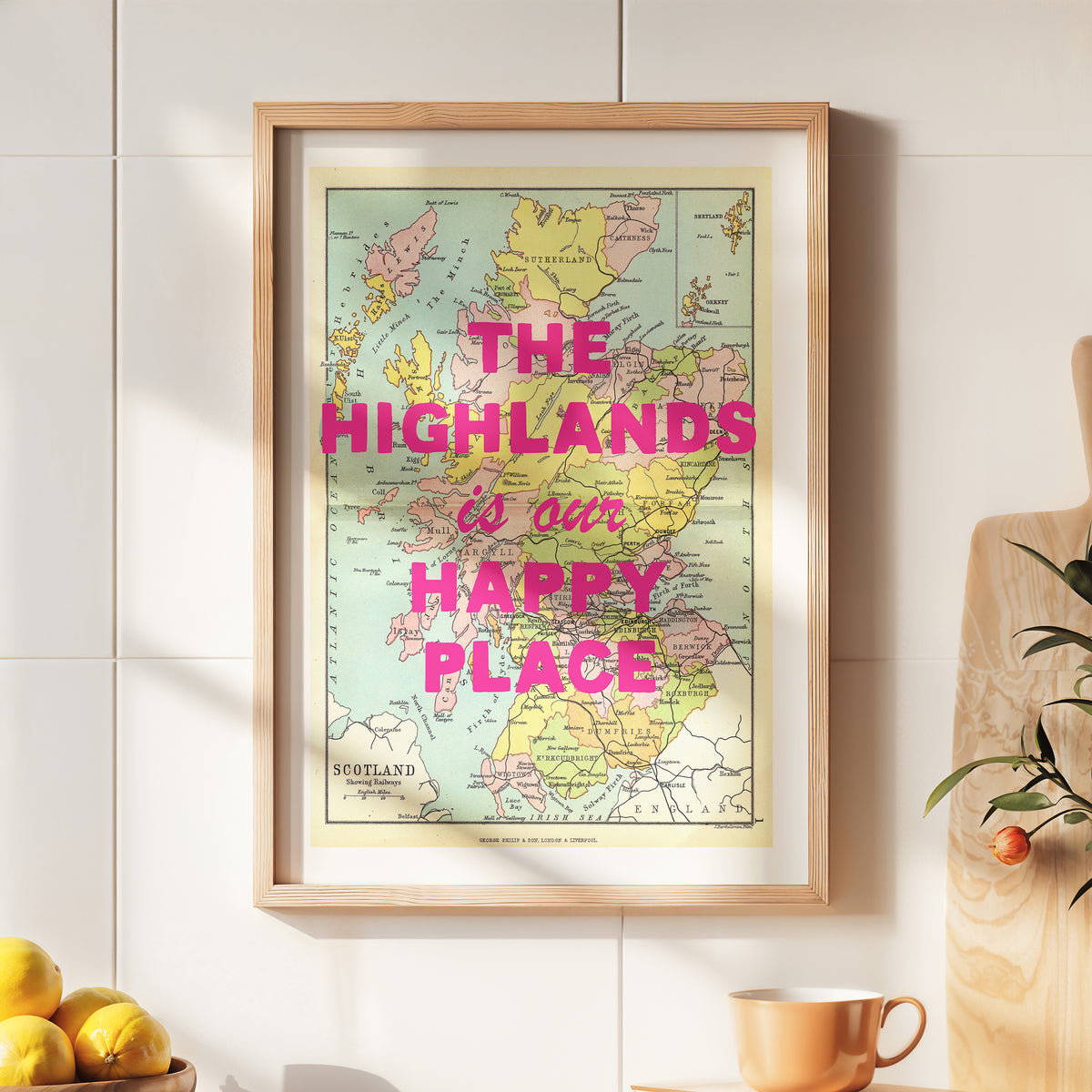 Framed map with 'The Highlands is our happy place' text on a wall.