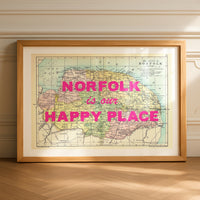 Framed map of Norfolk with 'norfolk is our happy place' text on a wall.