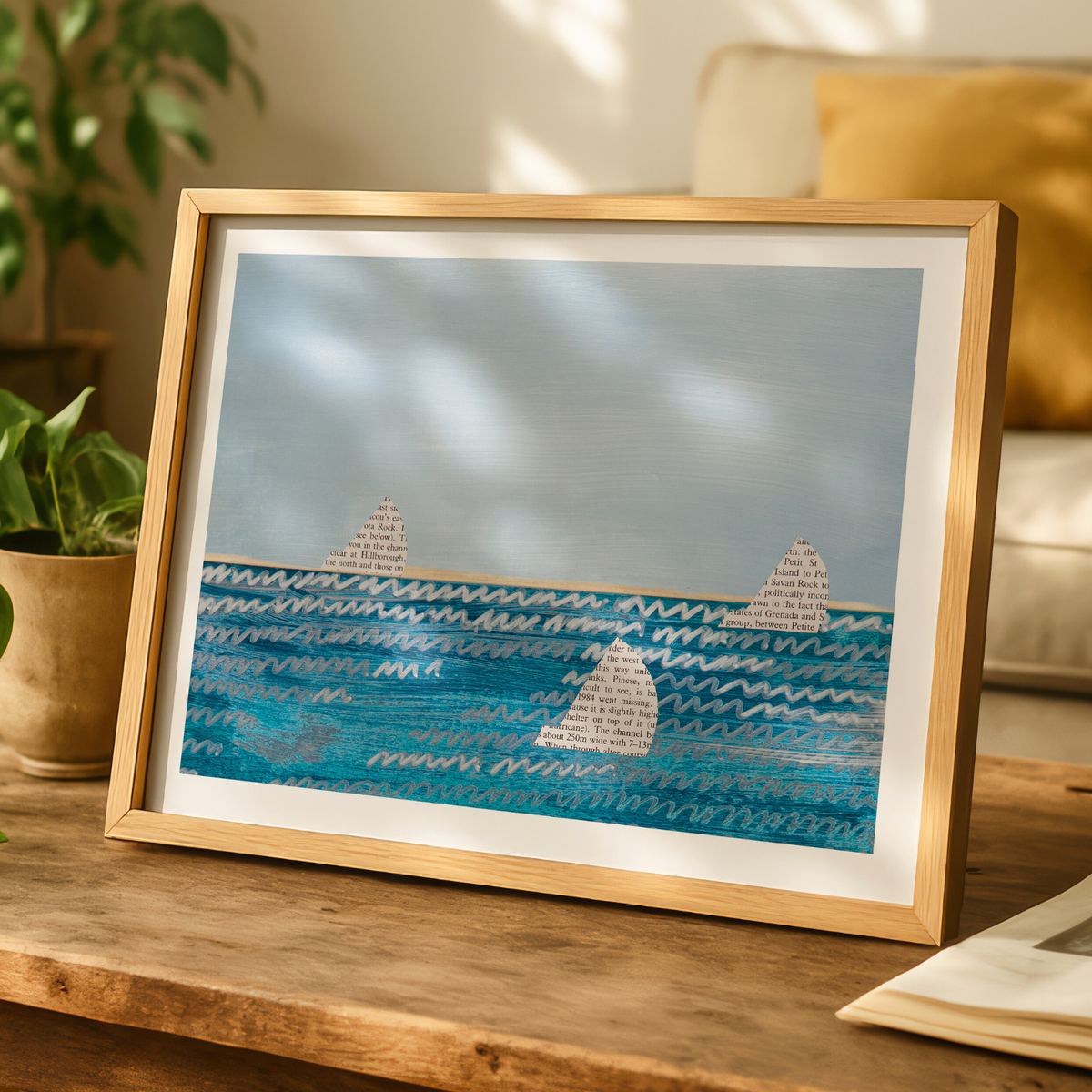 Framed sailing boat artwork with paper sails on blue sea, coastal wall art in neutral interior