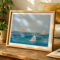 Framed sailing boat artwork with paper sails on blue sea, coastal wall art in neutral interior