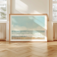Soft pastel beach painting with seafoam tones and shoreline, framed coastal wall art in living room
