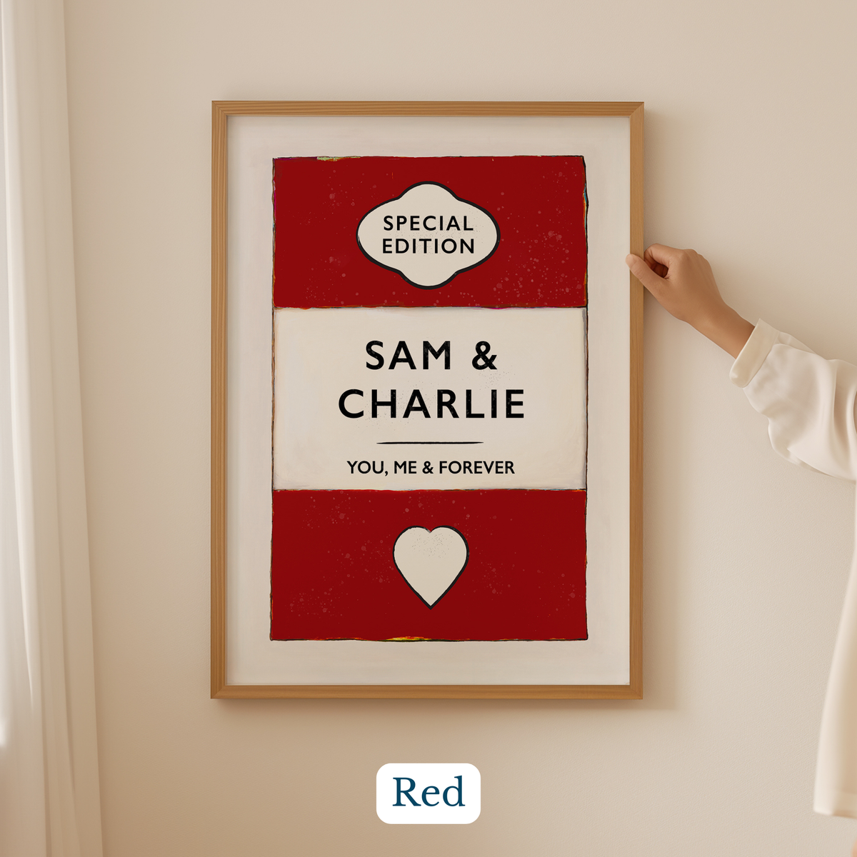 Personalised couple name print 1st anniversary paper gift. Framed artwork with 'Special Edition' and 'Sam & Charlie' text on a red and white background, held by a person.