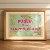 Framed map of Italy with 'Puglia is our happy place' text on a wooden floor.