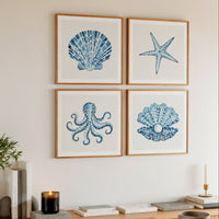 Set of four shell art prints on wall in living room