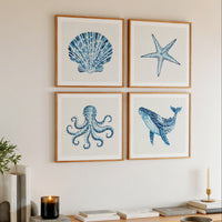 set of watercolour sealife paintings above sideboard in living room. Coastal living interior styling.