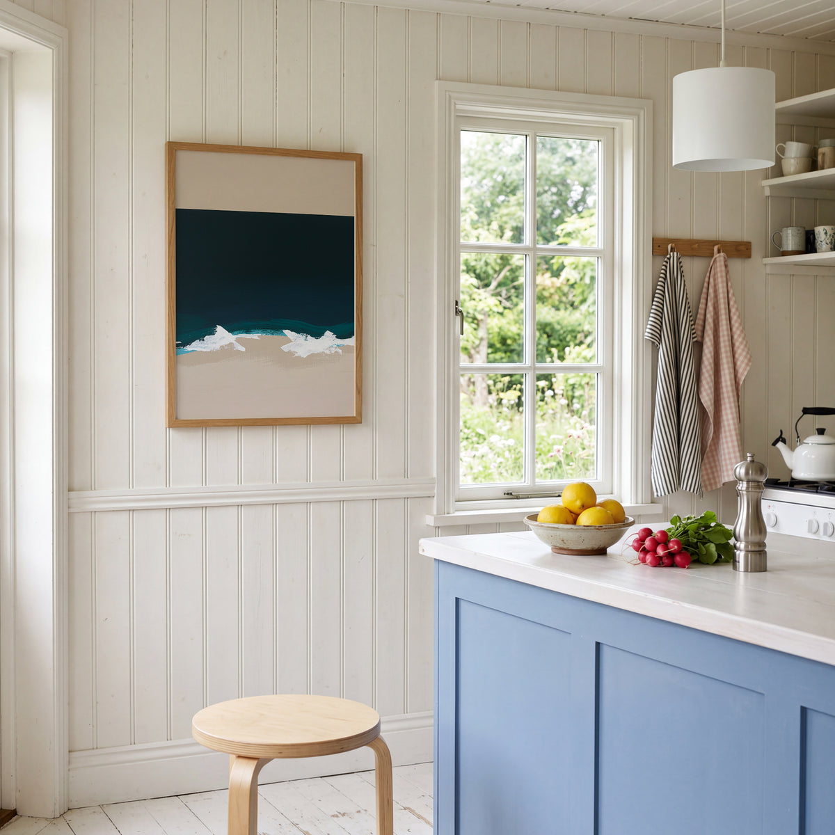 Kitchen interior with blue cabinets, white countertop, and a window view.