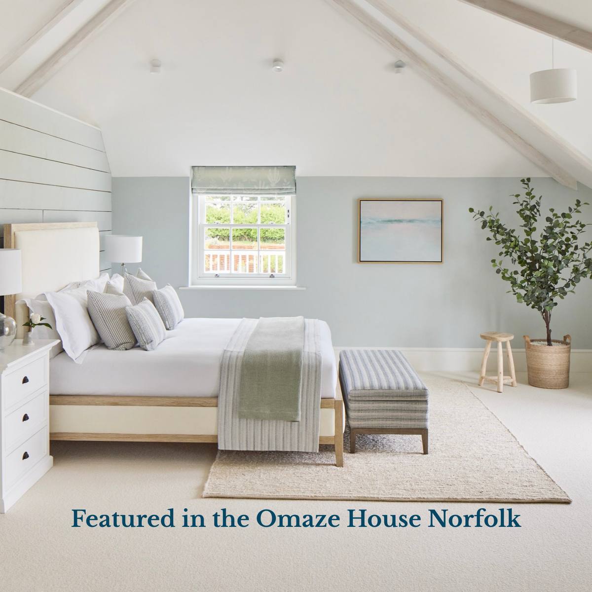 Tide beach painting in aqua in Modern bedroom with light blue walls, white bed, and decorative elements.