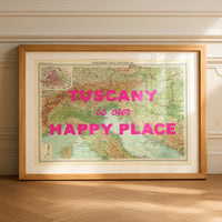 Framed map of Tuscany with 'Tuscany is our happy place' text on a wooden floor.