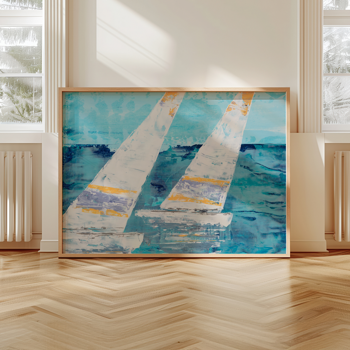 Framed abstract painting of sailboats on a wall in a room with large windows.
