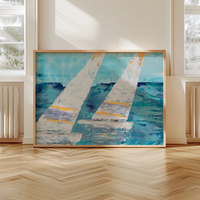 Framed abstract painting of sailboats on a wall in a room with large windows.