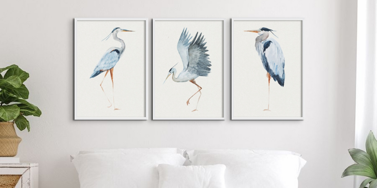 Set of three vintage art prints above bed - a collection of the best vintage art prints in the uk by beach house art