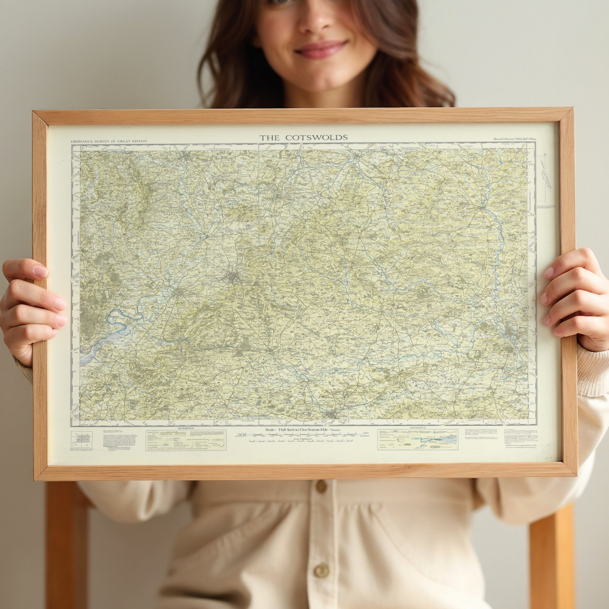 Person holding a vintage framed map print of The Cotswolds