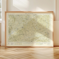Framed vintage map print of The Cotswolds on a wooden floor with a neutral wall background