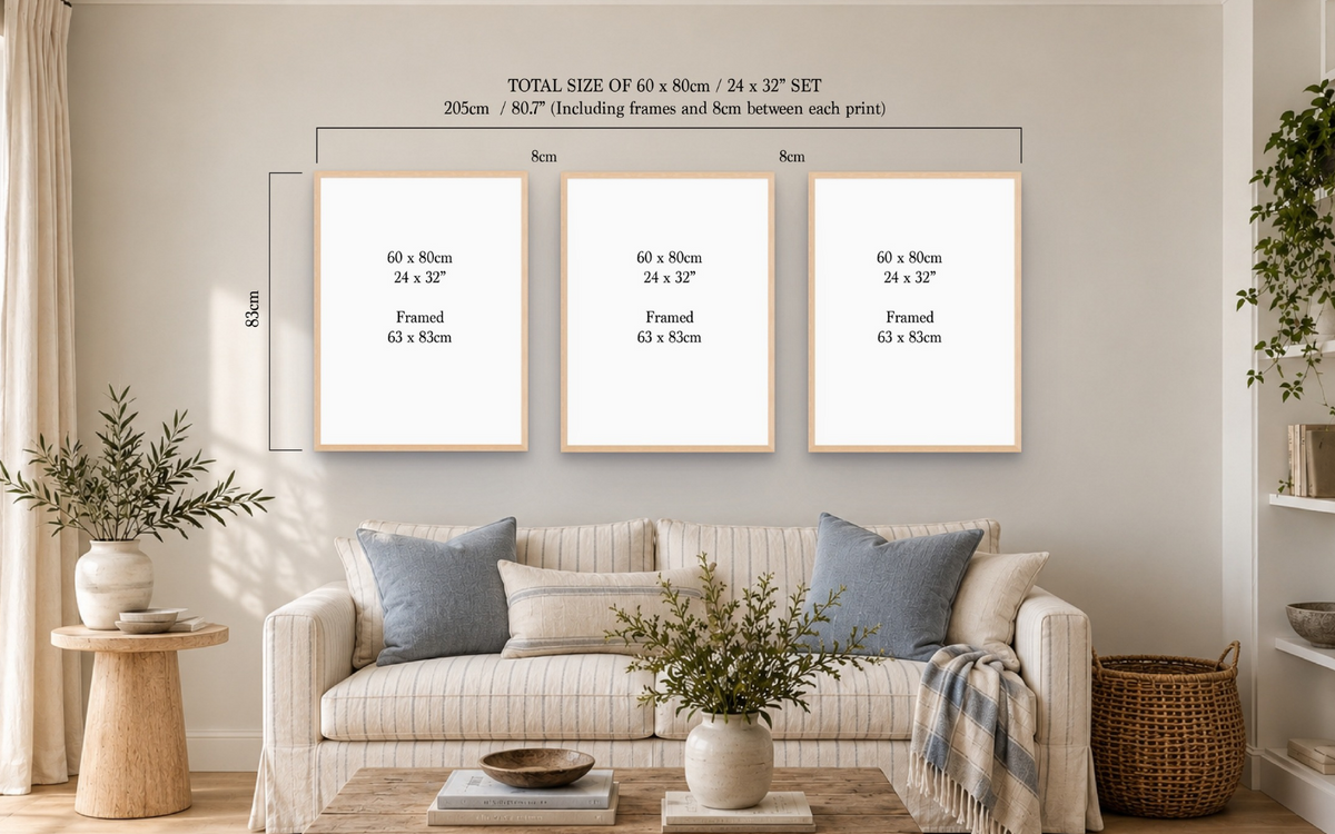 Three framed wall art prints displayed above a sofa in a styled living room. The prints are shown with dimension labels indicating a total size of 60 x 80 cm (24 x 32 in each) and 8 cm spacing between frames.
