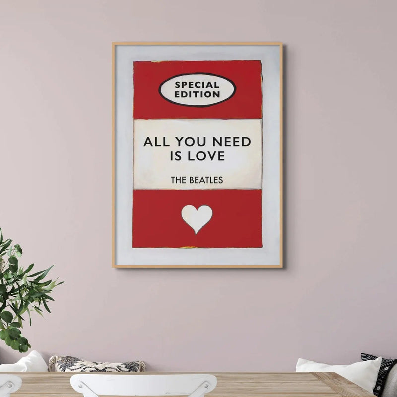 Vintage red book cover with All You Need is Love as the Title - Beach House Art on a pink wall above a white sideboard