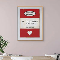 Vintage red book cover with All You Need is Love as the Title - Beach House Art on a pink wall above a white sideboard
