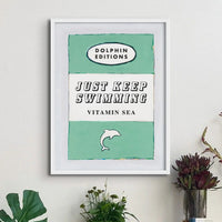 ramed book cover poster with white frame - Just keep swimmong is written in large font in the centre and is perfect for wild swimmers or cold water swimming enthusiasts