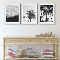 set of three black and white beach photographs above a coastal sideboard - Beach House Art