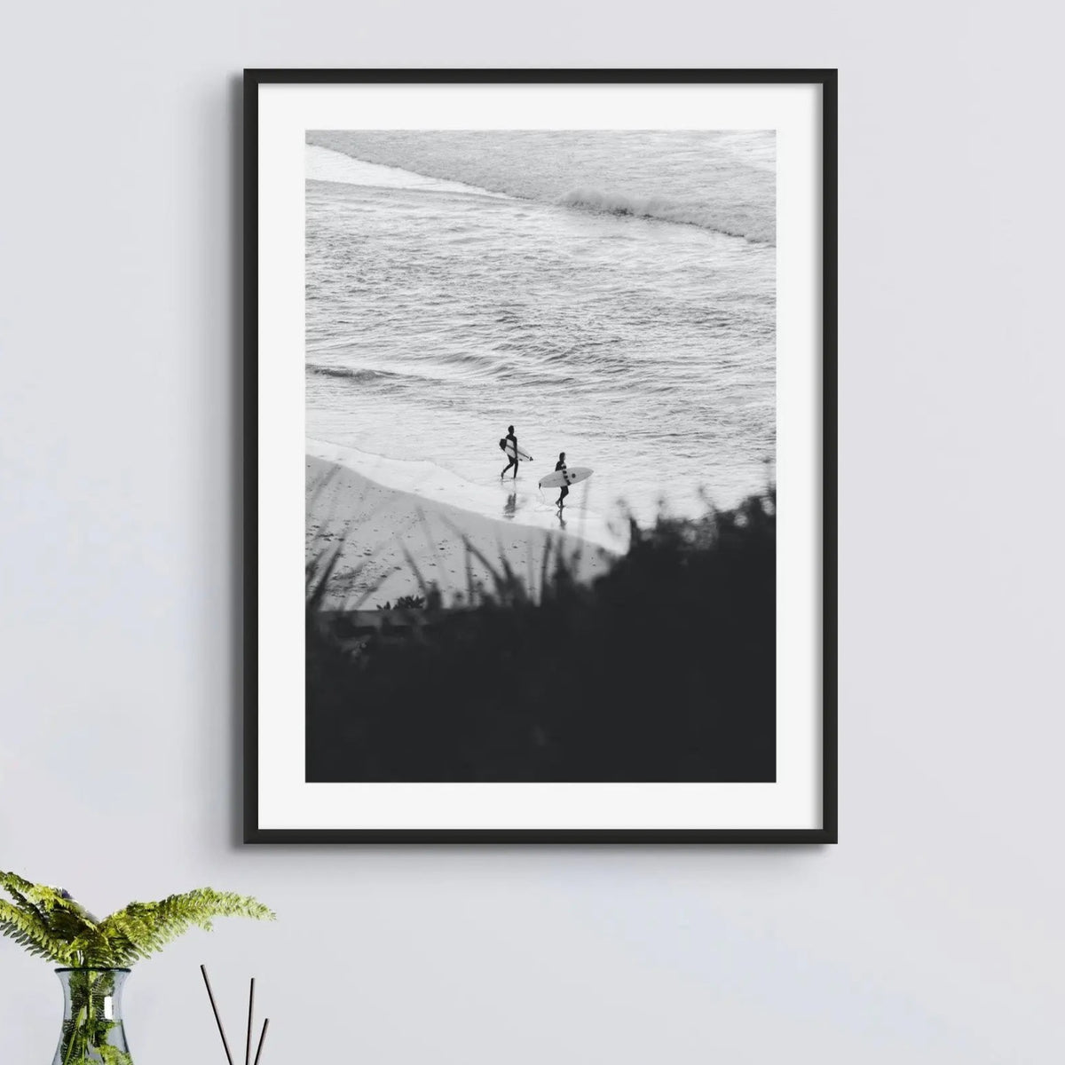 black & white photograph of surfers on the beach framed above a side table - beach house art