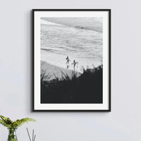 black & white photograph of surfers on the beach framed above a side table - beach house art