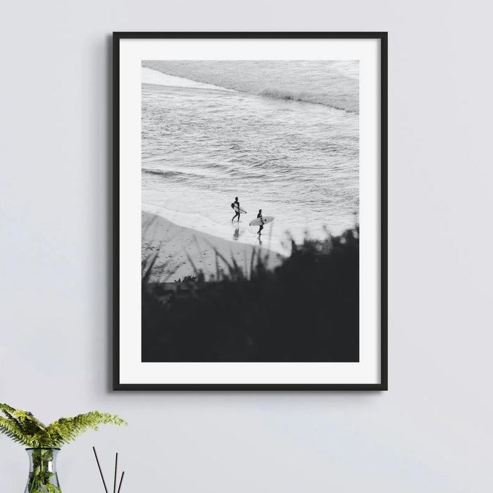 black & white photograph of surfers on the beach framed above a side table - beach house art