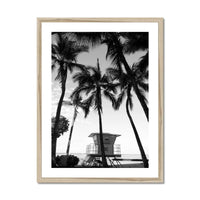 black & white beach art photograph of a life savers cabin in a palm tree grove in a natural frame - beach house art