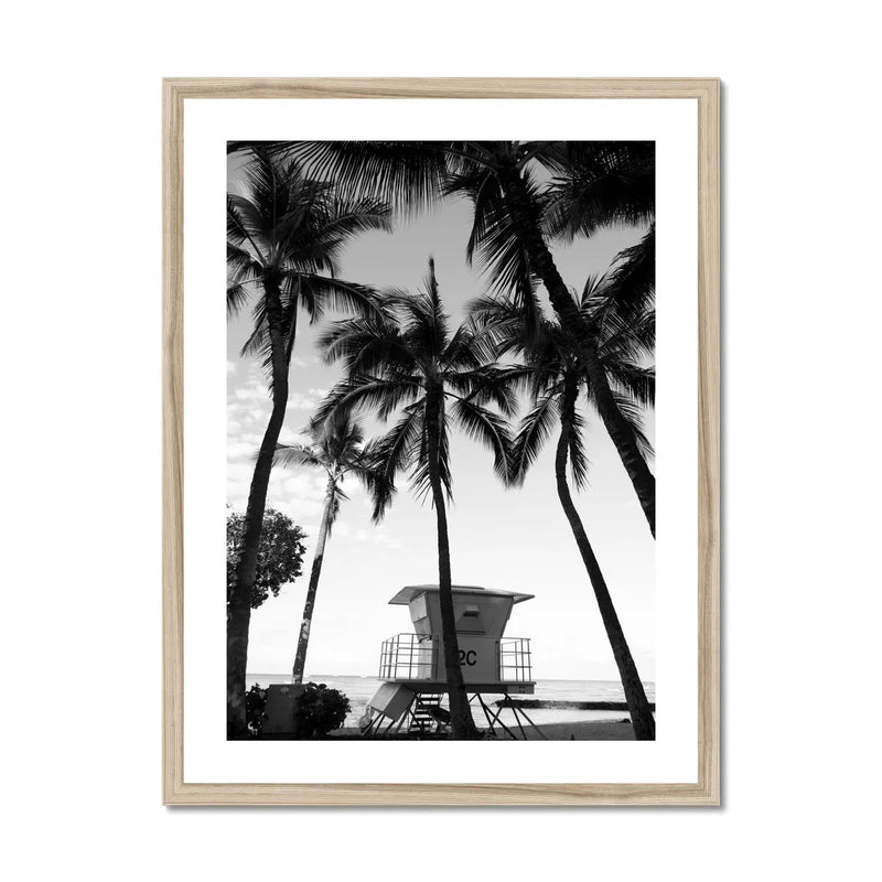 black & white beach art photograph of a life savers cabin in a palm tree grove in a natural frame - beach house art