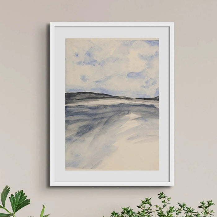 A framed watercolour painting depicting a coastal landscape with blue sky and clouds over a misty bay, set in a white frame in living room.