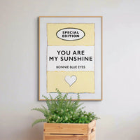 Beach House Art | You Are My Sunshine | Lyric Book Cover Art Print in white frame above pot plant