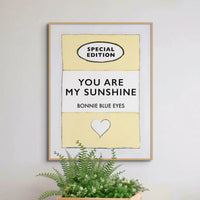 Beach House Art | You Are My Sunshine | Lyric Book Cover Art Print in white frame above a plant